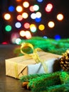 Christmas dark black background, gift and fir branches, magic shining bokeh, empty space for text Royalty Free Stock Photo