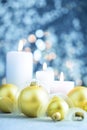 Christmas light blue background with candles and baubles Royalty Free Stock Photo