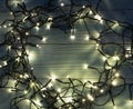 Christmas Light or Garland Lights on Wood Background Royalty Free Stock Photo