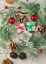 Christmas light gray background on whitewashed wooden boards with green spruce wreath, toys, silver snowflakes and gifts Royalty Free Stock Photo