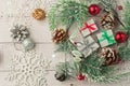 Christmas light gray background on whitewashed wooden boards with green spruce wreath, toys, silver snowflakes and gifts Royalty Free Stock Photo