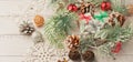 Christmas light gray background on whitewashed wooden boards with green spruce wreath, toys, silver snowflakes and gifts Royalty Free Stock Photo