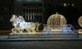 Christmas: Light shooting: festive glowing street decoration. Light sculpture,figure of Cinderella\'s carriage and horse