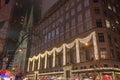 Christmas Light Show on a Huge Department Store`s Facade in New York Manhattan. Saint Patrick`s Cathedral Next to it