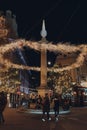 Christmas lights around the column in Seven Dials, Covent Garden, London, UK, people around Royalty Free Stock Photo