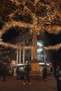 Christmas lights around the column in Seven Dials, Covent Garden, London, UK, people around Royalty Free Stock Photo