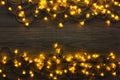 Christmas lights border on grey wooden background Royalty Free Stock Photo