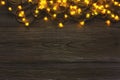 Christmas lights border on grey wooden background Royalty Free Stock Photo