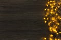 Christmas lights border on grey wooden background Royalty Free Stock Photo