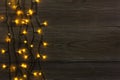 Christmas lights border on grey wooden background Royalty Free Stock Photo