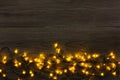 Christmas lights border on grey wooden background Royalty Free Stock Photo