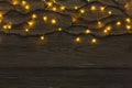 Christmas lights border on grey wooden background Royalty Free Stock Photo