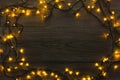 Christmas lights frame on grey wooden background Royalty Free Stock Photo