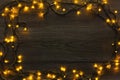 Christmas lights frame on wood grey background Royalty Free Stock Photo