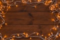 Christmas lights frame on wood background Royalty Free Stock Photo