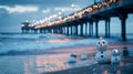Christmas lights on beach pier, sand snowmen, ocean waves . Royalty Free Stock Photo