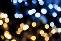 Christmas lights. Bokeh glows on a dark background. Christmas garlands with a blurred focus in the form of gold and blue bokeh Royalty Free Stock Photo