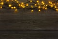 Christmas lights border on grey wooden background Royalty Free Stock Photo