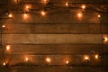 Christmas lights bulb decoration on old wood plank, frame border design Royalty Free Stock Photo