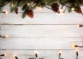 Christmas lights bulb and pine leaves decoration on wood table