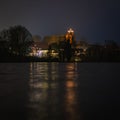 Christmas lights of a church reflected in a lake  in the dark Royalty Free Stock Photo