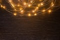 Christmas lights frame decoration on dark wood with copy space. Merry Christmas and New Year holiday background Royalty Free Stock Photo