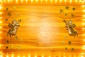 Christmas lights frame on golden wood background with copy space Royalty Free Stock Photo