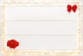 Christmas lights and gift box with red ribbon on white wooden background. Flat lay, top view, copy space Royalty Free Stock Photo