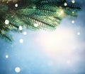 Christmas lights and pine branches and snow. Winter. Christmas. Blue festive winter background Royalty Free Stock Photo