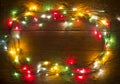 Christmas lights on plank background. Holiday backdrop. Colorful lights on rustic wooden background for xmas, new year design