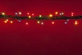 Christmas lights on red background. Multicolored lighton red background..