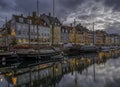 Christmas lights reflect in Copenhagen Nyhavn canal at dusk