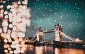 christmas lights and snow in London Tower bridge at night Royalty Free Stock Photo