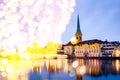 christmas lights and snow in  Zurich city center with famous Fraumunster and Grossmunster Churches and river Limmat at Lake Zurich Royalty Free Stock Photo