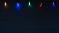 Christmas Lights on String Glowing against a Dark Navy Blue Wood Board Background with Copy Space below with a horizontal crop