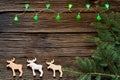 Christmas lights on a wooden background with free space. Gingerbread in the shape of animals. In the background of twigs Christmas Royalty Free Stock Photo