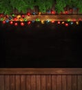 Christmas lights on wooden blackboard