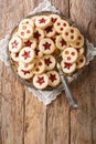 Christmas Linzer cookies stuffed with strawberry and apricot jam  close-up on the plate. Vertical top view Royalty Free Stock Photo