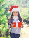 Christmas little girl child in santa hat with gift box Royalty Free Stock Photo