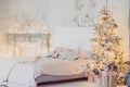 Christmas living room with a Christmas tree, gifts and bed. Beautiful New Year decorated classic home interior. Winter background Royalty Free Stock Photo