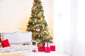 Christmas living room with a Christmas tree, sofa, gifts and a large window. Beautiful New Year decorated classic home interior Royalty Free Stock Photo