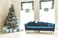 Christmas living room with a Christmas tree, sofa, gifts and a large window. Beautiful New Year decorated classic home interior Royalty Free Stock Photo