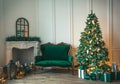 Christmas living room with a fireplace, sofa, Christmas tree and gifts. Beautiful New Year decorated classic home interior. Winter Royalty Free Stock Photo