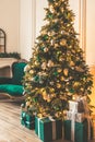 Christmas living room with a fireplace, sofa, Christmas tree and gifts. Beautiful New Year decorated classic home interior. Winter Royalty Free Stock Photo