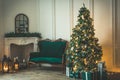 Christmas living room with a fireplace, sofa, Christmas tree and gifts. Beautiful New Year decorated classic home interior. Winter Royalty Free Stock Photo
