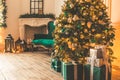 Christmas living room with a fireplace, sofa, Christmas tree and gifts. Beautiful New Year decorated classic home interior. Winter Royalty Free Stock Photo