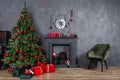 Christmas living room interior design with xmas tree decorated garland and ball, presents, gifts, fireplace and candles Royalty Free Stock Photo