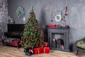 Christmas living room interior design with xmas tree decorated garland and ball, presents, gifts, fireplace and candles Royalty Free Stock Photo