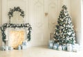 Christmas living room with a Christmas tree, fireplace, gifts and a large window. Beautiful New Year decorated classic home interi Royalty Free Stock Photo