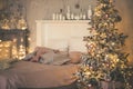 Christmas living room with a Christmas tree, gifts and bed. Beautiful New Year decorated classic home interior. Winter background Royalty Free Stock Photo